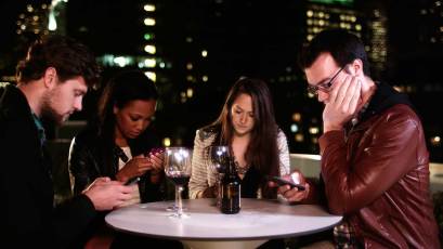 four-people-at-the-table-with-phones